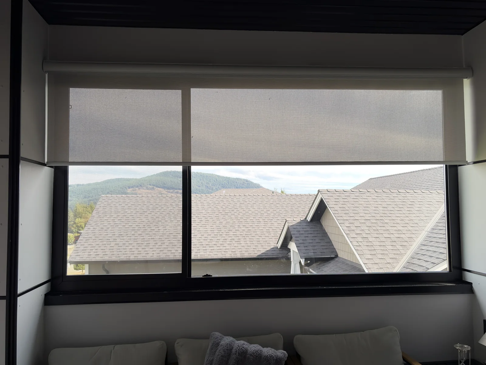 A light-filtering roller shade in a bedroom