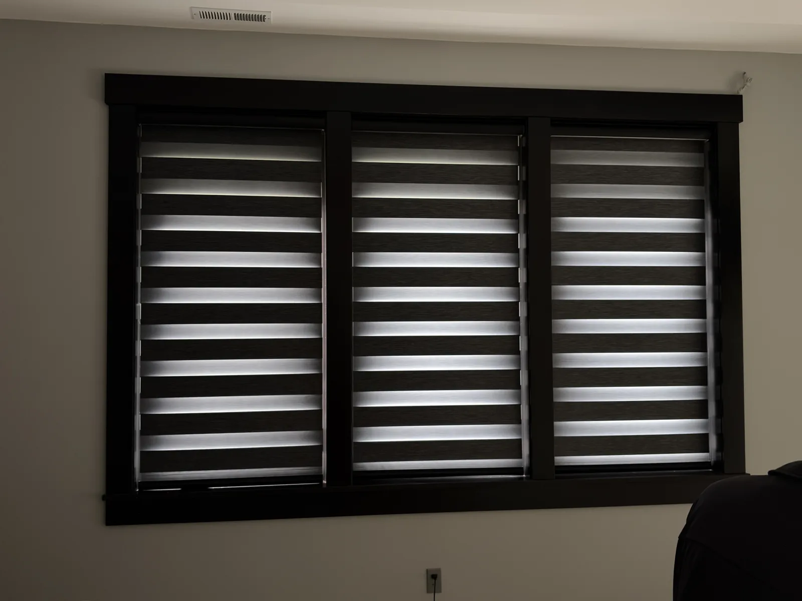 Zebra blinds across a wide window