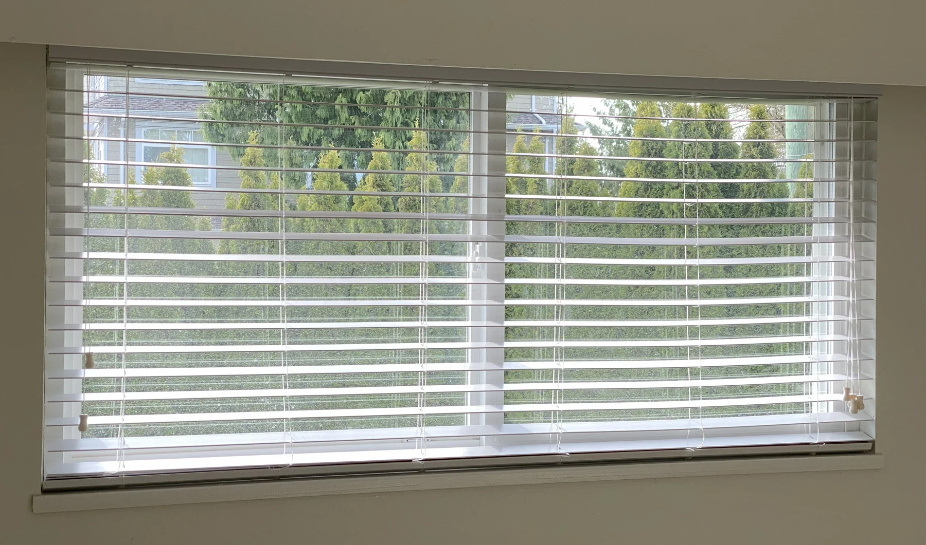 Faux wood blinds across multiple windows